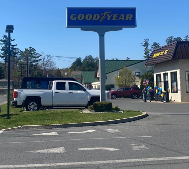 Warren Tire Service Center Queensbury location on Lafayette Avenue with Goodyear Tire sign showing, the street exit, and the shop in the background